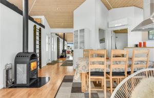 a kitchen and dining room with a wood stove at Three-Bedroom Holiday Home Nordborg With A Room Hot Tub 01 in Nordborg