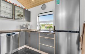 a kitchen with stainless steel appliances and a window at Three-Bedroom Holiday Home Nordborg With A Room Hot Tub 01 in Nordborg