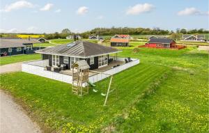 a small house with a playground in a field at Three-Bedroom Holiday Home Nordborg With A Room Hot Tub 01 in Nordborg +13 photos