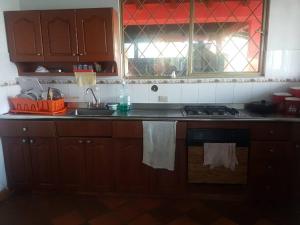 a kitchen with a sink and a stove top oven at Espectacular casa de campo en finca cafetera in Moniquirá