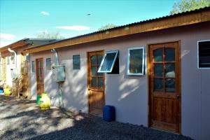 a building with doors and a solar panel on it at El Yatiri in San Pedro de Atacama