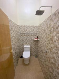 a bathroom with a white toilet in a room at Az HOMESTAY PENDANG KEDAH in Pendang