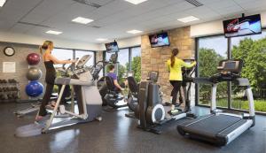 a gym with people exercising on elliptical machines at Chauncey Hotel and Conference Center in Princeton