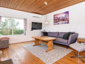 ein Wohnzimmer mit einem Sofa und einem Tisch in der Unterkunft Holiday home Broager in Broager