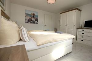 a bedroom with a bed with lights on it at Aquamarin Ostseetraumsuite 12 in Neuhaus