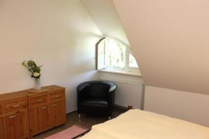 - une chambre avec une chaise, un bureau et une fenêtre dans l'établissement Strandhaus Strandhaus, App 01, à Dierhagen