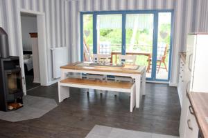 a living room with a table and a couch at Haus Ostseeidyll, App 01 in Neuhaus +12 photos