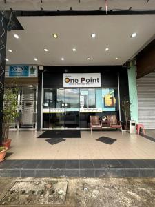 a one point store with two chairs in front of it at One Point Hotel @ Airport (Kuching) in Kuching