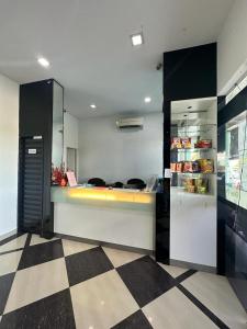 a kitchen with a counter and a refrigerator at One Point Hotel @ Airport (Kuching) in Kuching