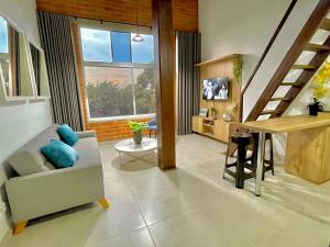 a living room with a couch and a table at APARTAMENTOS EN LAURELES, MEDELLÍN in Medellín