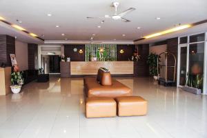 a lobby with a couch in the middle of a room at The Tusita Hotel in Kuta