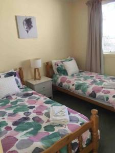 a bedroom with two beds and a window at RELAX on Ronald Street in Devonport
