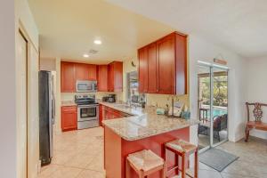 a kitchen with wooden cabinets and a counter top at Fun In The Sun: Canal Access in Cape Coral