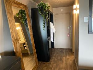 a hallway with a mirror and a hallway with a bathroom at Travelodge by Wyndham Drummondville in Drummondville
