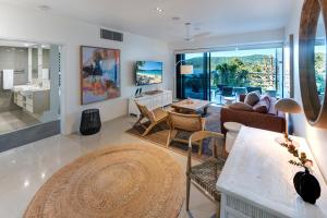 a living room with a couch and a table at North Cape 5 on Hamilton Island by HIHA in Hamilton Island