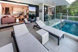 a house with a swimming pool and a living room at North Cape 5 on Hamilton Island by HIHA in Hamilton Island