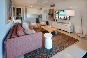a living room with a couch and a table at North Cape 5 on Hamilton Island by HIHA in Hamilton Island