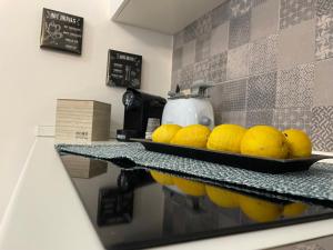 a tray of lemons on a counter in a kitchen at A piscaria in Catania