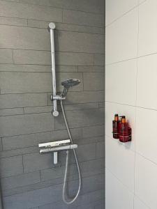 a shower with a shower head in a bathroom at Villa Victoria with sauna in Ermelo in Ermelo