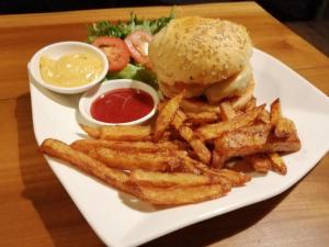 a plate of food with a hamburger and french fries at Tad Lo - FANDEE ISLAND - Mountain House - Bolaven Loop Pakse in Ban Kiangtat