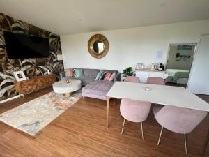 sala de estar con sofá, mesa y sillas en Gold Coast Retreat, en Ormeau