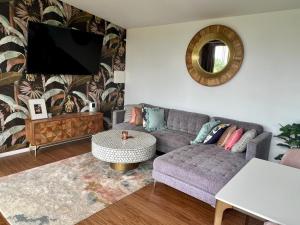 a living room with a couch and a tv at Gold Coast Retreat in Ormeau