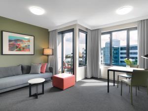 a living room with a couch and a table at Adina Apartment Hotel Sydney Airport in Sydney