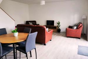 a living room with a couch and chairs and a table at Secluded Modern Guest House in Castletown Gheoghegan