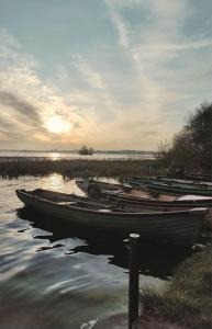 a group of boats sitting in the water at Secluded Modern Guest House in Castletown Gheoghegan
