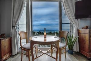 a dining room with a table and chairs and a window at Breezy Beachfront Bali-Style Haven 180 Degree OceanView in Hauula