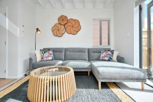 a living room with a couch and a table at Āta Haere - Christchurch Holiday Homes in Christchurch