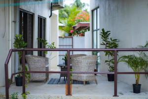 a balcony with chairs and a table and plants at Yaubula Accommodation in Nadi