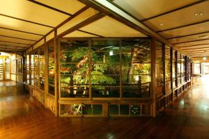 a large glass building with plants in it at yukairouKikuya in Izu