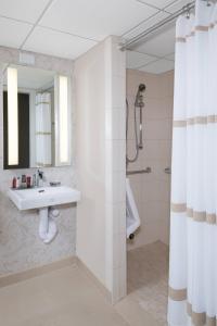 a bathroom with a sink and a shower at Durham Marriott City Center in Durham