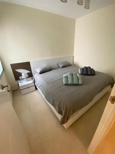 a bedroom with a large bed with two pillows at FRONTIMAR in Calpe