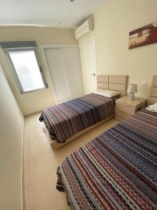 a bedroom with two beds and a window at FRONTIMAR in Calpe