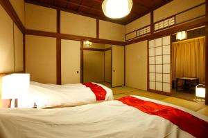 Letto o letti in una camera di Yukairo Kikuya