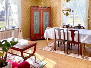 a dining room with a table and chairs in it at 4 person holiday home in VIMMERBY-By Traum in Vimmerby +18 photos