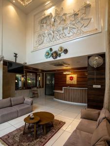 a living room with a couch and a table at M Square Hotel in Hyderabad