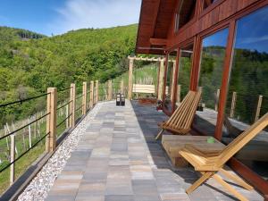 a balcony of a house with two chairs on it at Hiška oddiha - Rest house in Sromlje