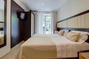 a bedroom with a large bed and a window at Splendid Luxury Apartments in Budva