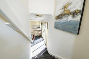 a hallway of a house with a painting on the wall at Charming Convenient 2BR Compact House Ringwood in Ringwood