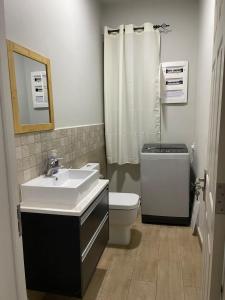 a bathroom with a sink and a toilet and a shower at Perfect Escape - Bel appartement proche de la plage Trou Aux Biches in Trou aux Biches