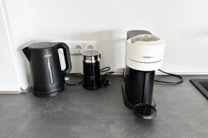 a coffee maker and a coffeemaker sitting on the floor at Maisonette Apartment in Krefeld mit 2 Balkone in Krefeld
