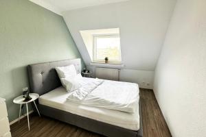 a small bedroom with a bed and a window at Maisonette Apartment in Krefeld mit 2 Balkone in Krefeld