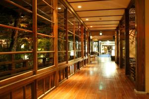 a hallway of a building with wooden floors and windows at yukairouKikuya in Izu