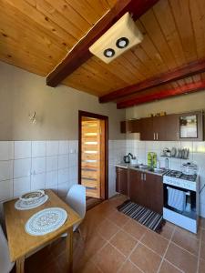 a kitchen with a table and a stove top oven at CICHY ZAKĄTEK in Borysówka