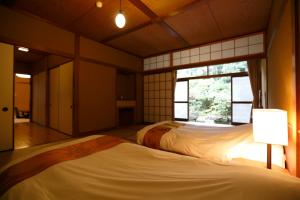 Letto o letti in una camera di Yukairo Kikuya
