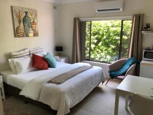 a bedroom with a bed and a large window at Hotel Style Monterey Guest Studio near Hospitals, Beach and Airport in Sydney
