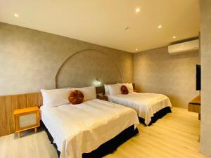 Postel nebo postele na pokoji v ubytování Cingjing Florence Resort Villa